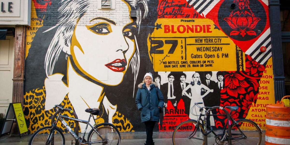 Amy Richards stands in front of street art in NYC | © Phil Provencio/Unearth Women