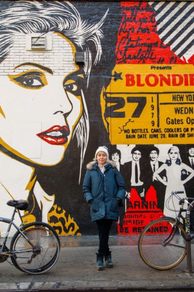 Amy Richards stands in front of street art in NYC | © Phil Provencio/Unearth Women