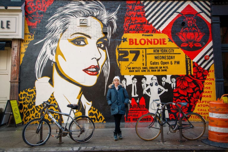 Amy Richards stands in front of street art in NYC | © Phil Provencio/Unearth Women