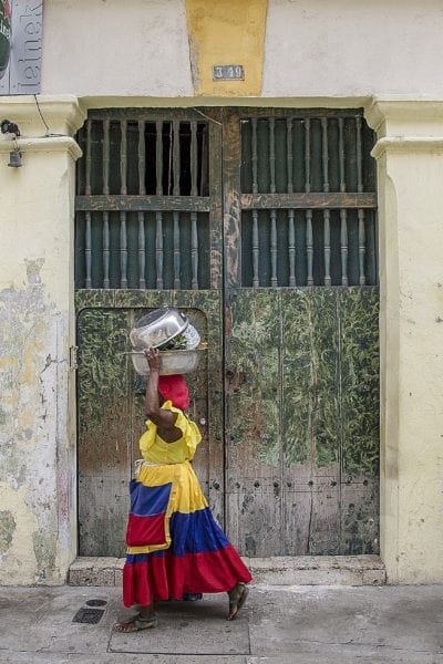 A local Colombian woman walks the streets of Cartagena © | ShonEjai/Pixabay