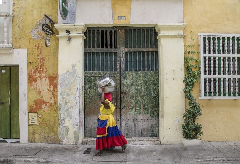 A local Colombian woman walks the streets of Cartagena © | ShonEjai/Pixabay