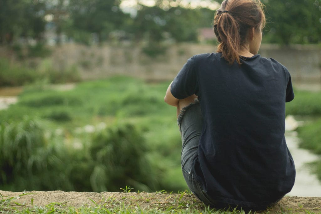 A lone woman looks out over a view © | Lifestyle5933/Shutterstock