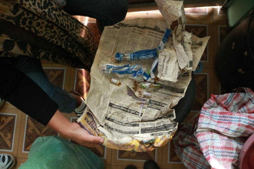 Ex-user and Dristi volunteer, Punam Rai, in the Dristi office in Dharan shows drug paraphernalia © | Jenna Kunze