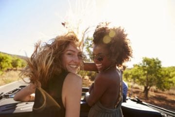 Two female travelers laughing | © Shutterstock.com
