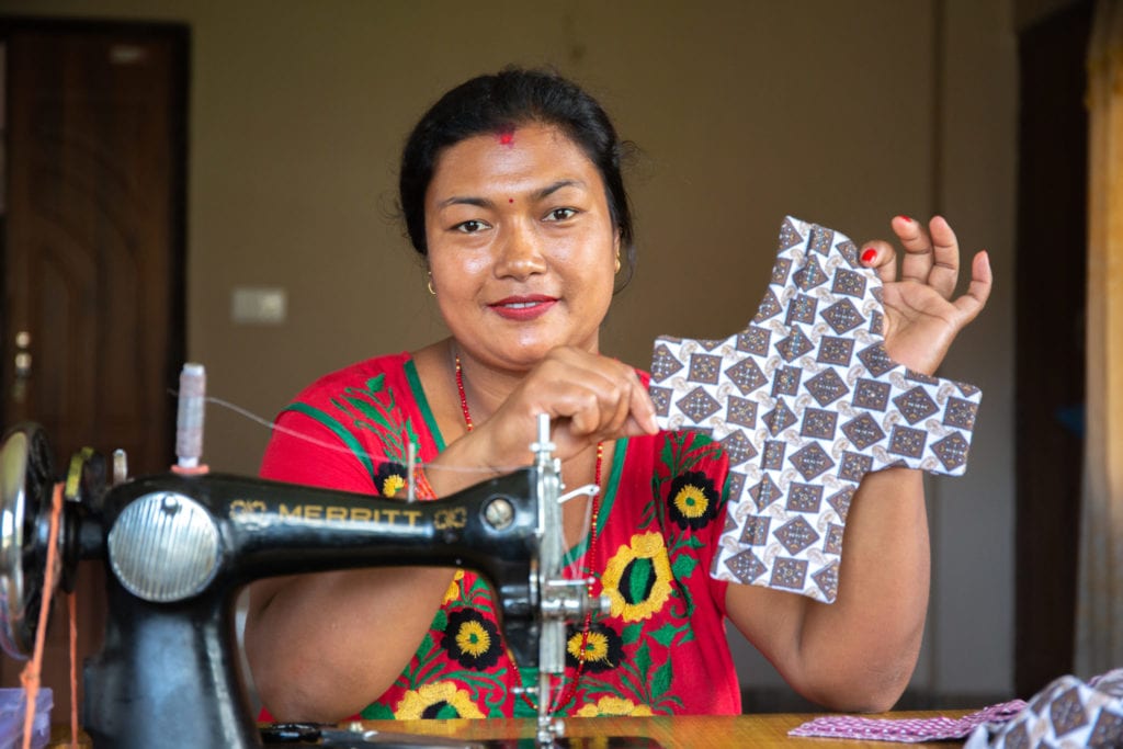 Sangita, 32, holds up a finished reusable sanitary pad | © WaterAid/ Mani Karmacharya