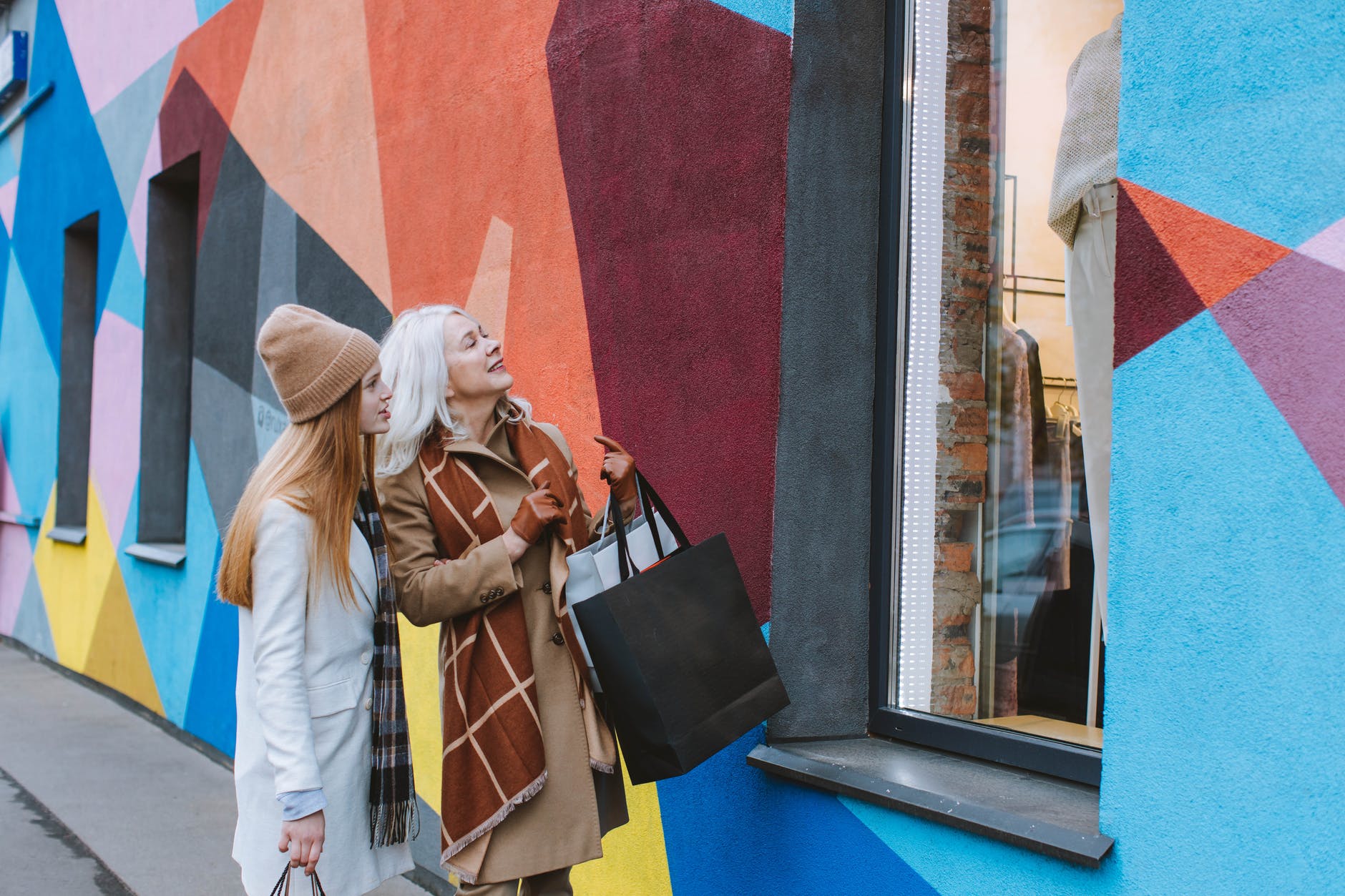 grandmother and teenage girl looking at the show window