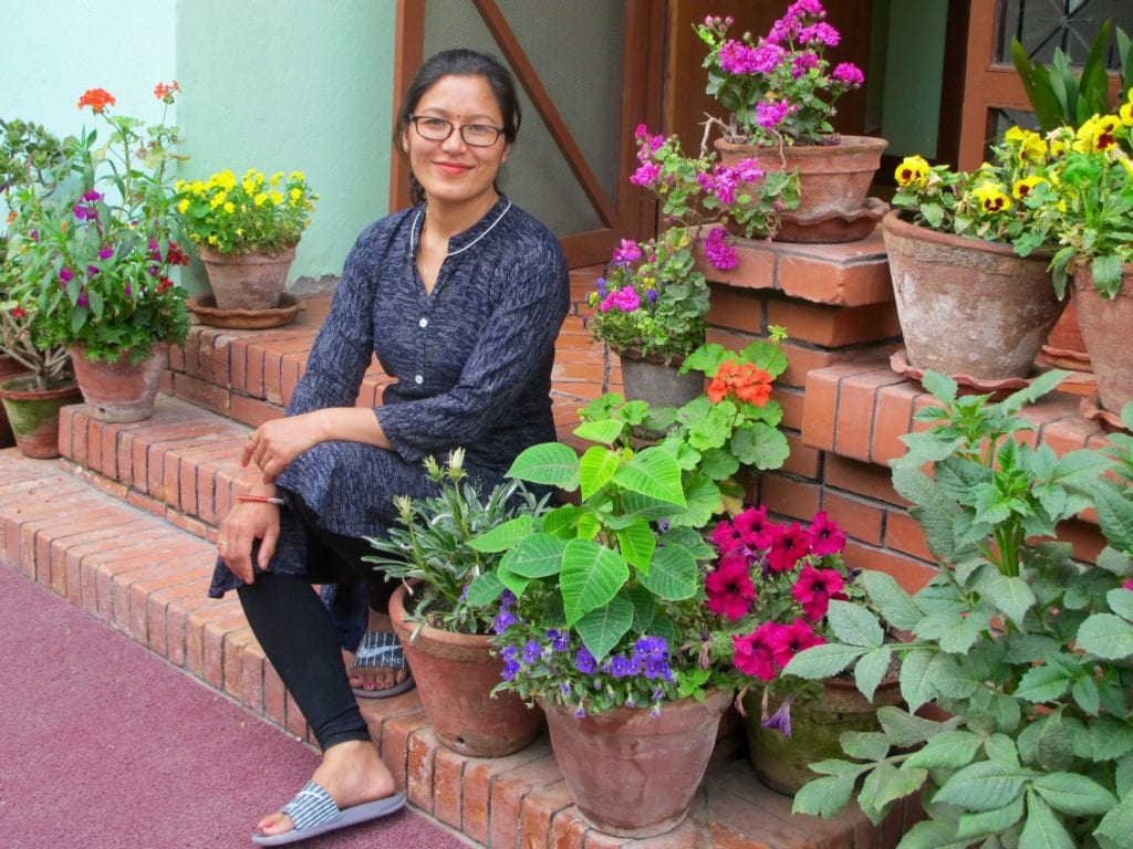 Dr. Padma Bajracharya on the stairs outside of Moksha Ayurveda & Panchakarma Center | © Rachel Jones