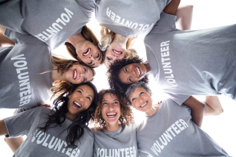 A group of female volunteers pose for a photo | © Shutterstock