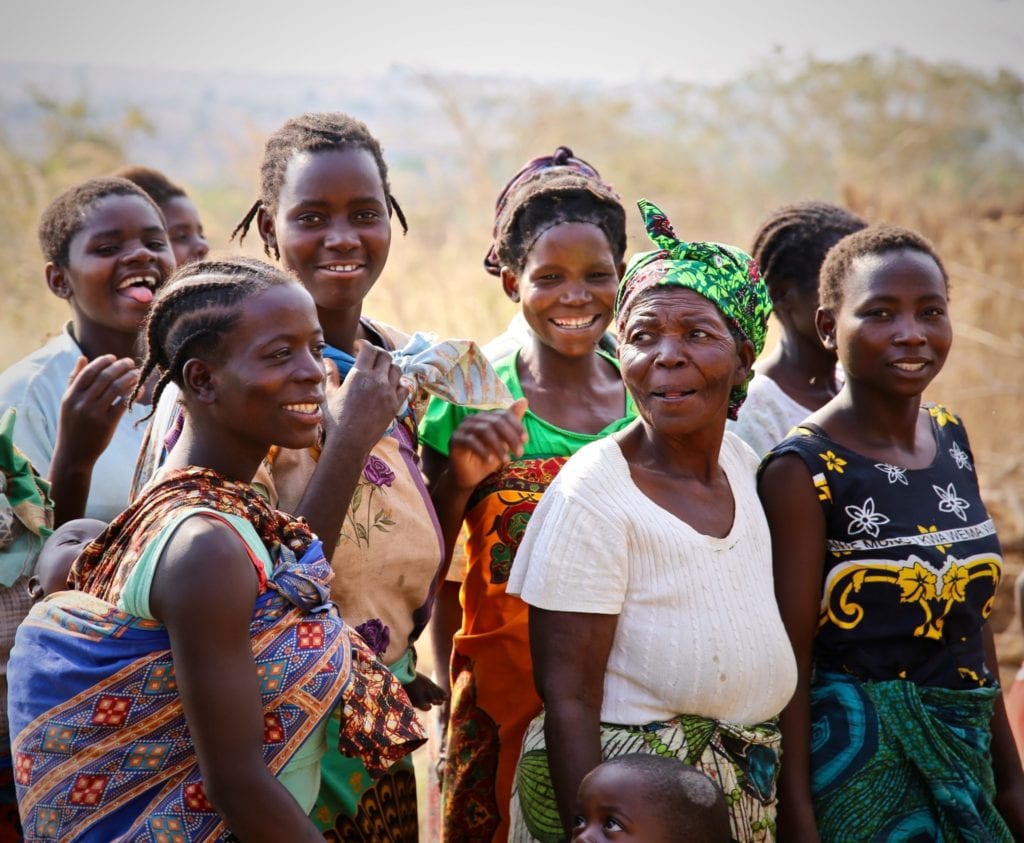 Women and girls post for a photo in a village in Malawi | © Oxford Media Library / Shutterstock