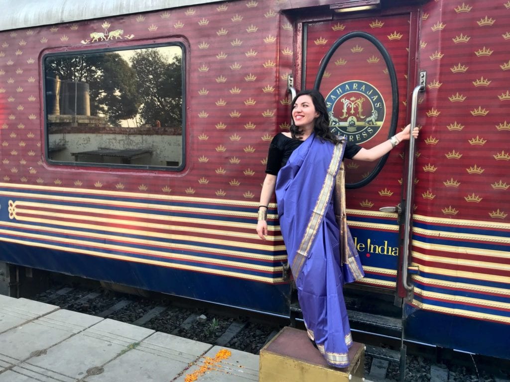 The author poses outside India's Maharaja Express | © Nikki Vargas