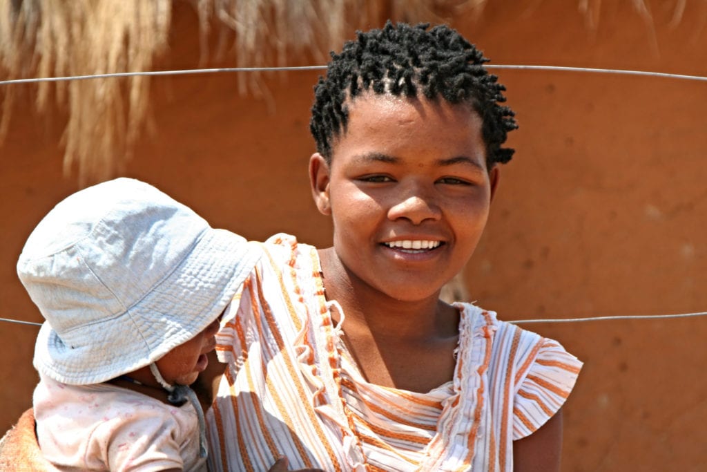 A San woman poses with her baby | © Rostasedlacek/Shutterstock