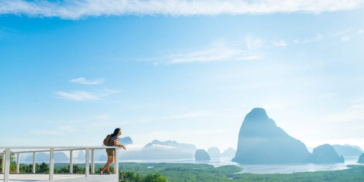 A woman looks out over a mountain view in Khao Samed Nang Chee Viewpoint in Thailand | © weedezign/Shutterstock
