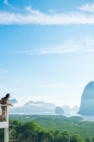 A woman looks out over a mountain view in Khao Samed Nang Chee Viewpoint in Thailand | © weedezign/Shutterstock