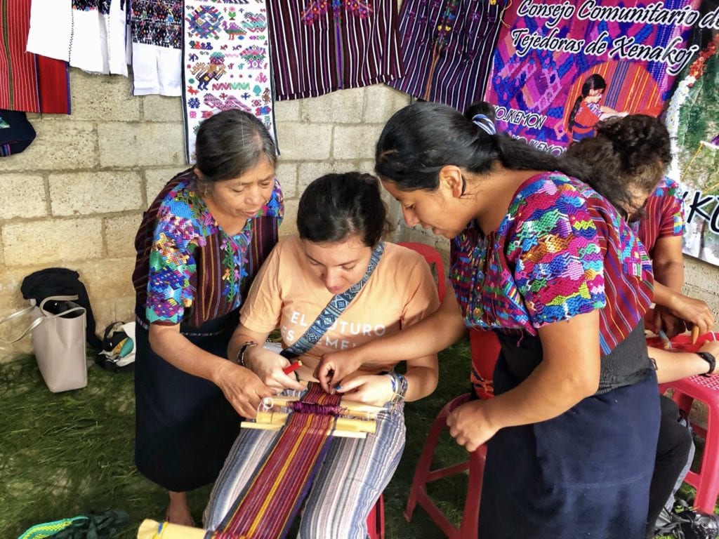 The women of the Consejo de Tejedoras de Santo Domingo Xenacoj show the author how to weave using a loom | © Nikki Vargas/Unearth Women