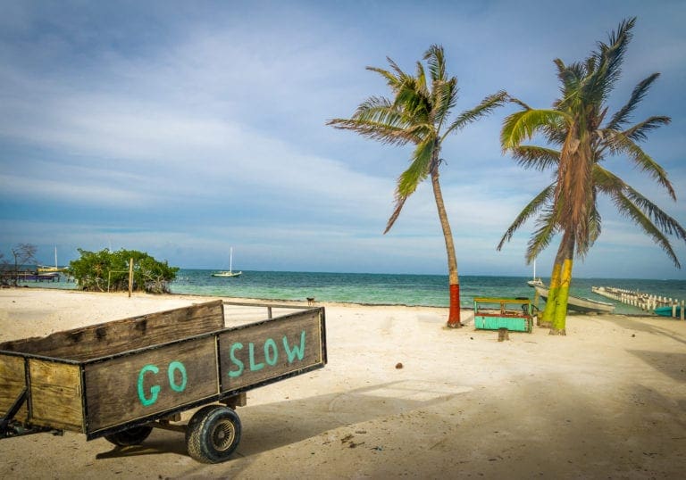A wooden cart shares the Caye Caulker slogan: Go Slow | © Diego Grandi