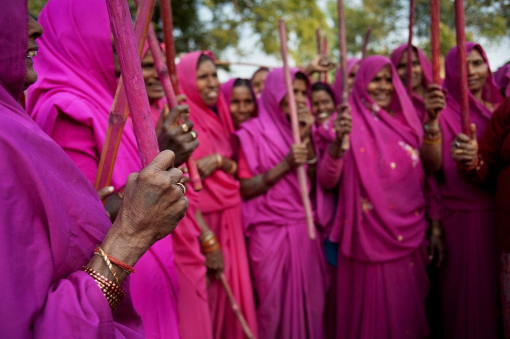 Gulabi Gang in pink saris, yielding their sticks | © Jonas Gratzer/LightRocket via Getty