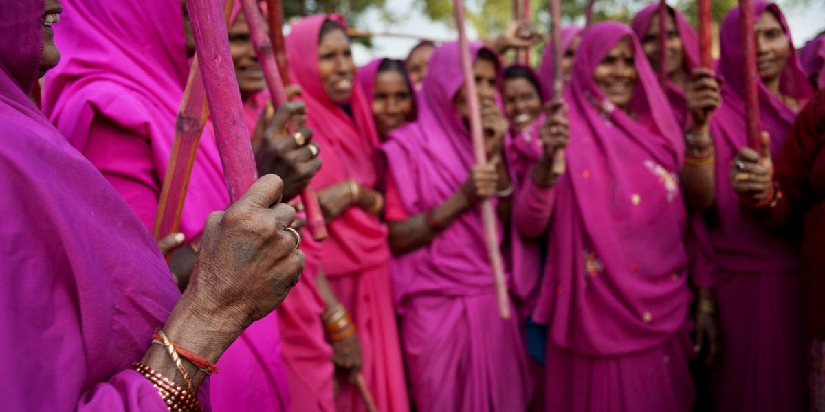 Gulabi Gang in pink saris, yielding their sticks | © Jonas Gratzer/LightRocket via Getty