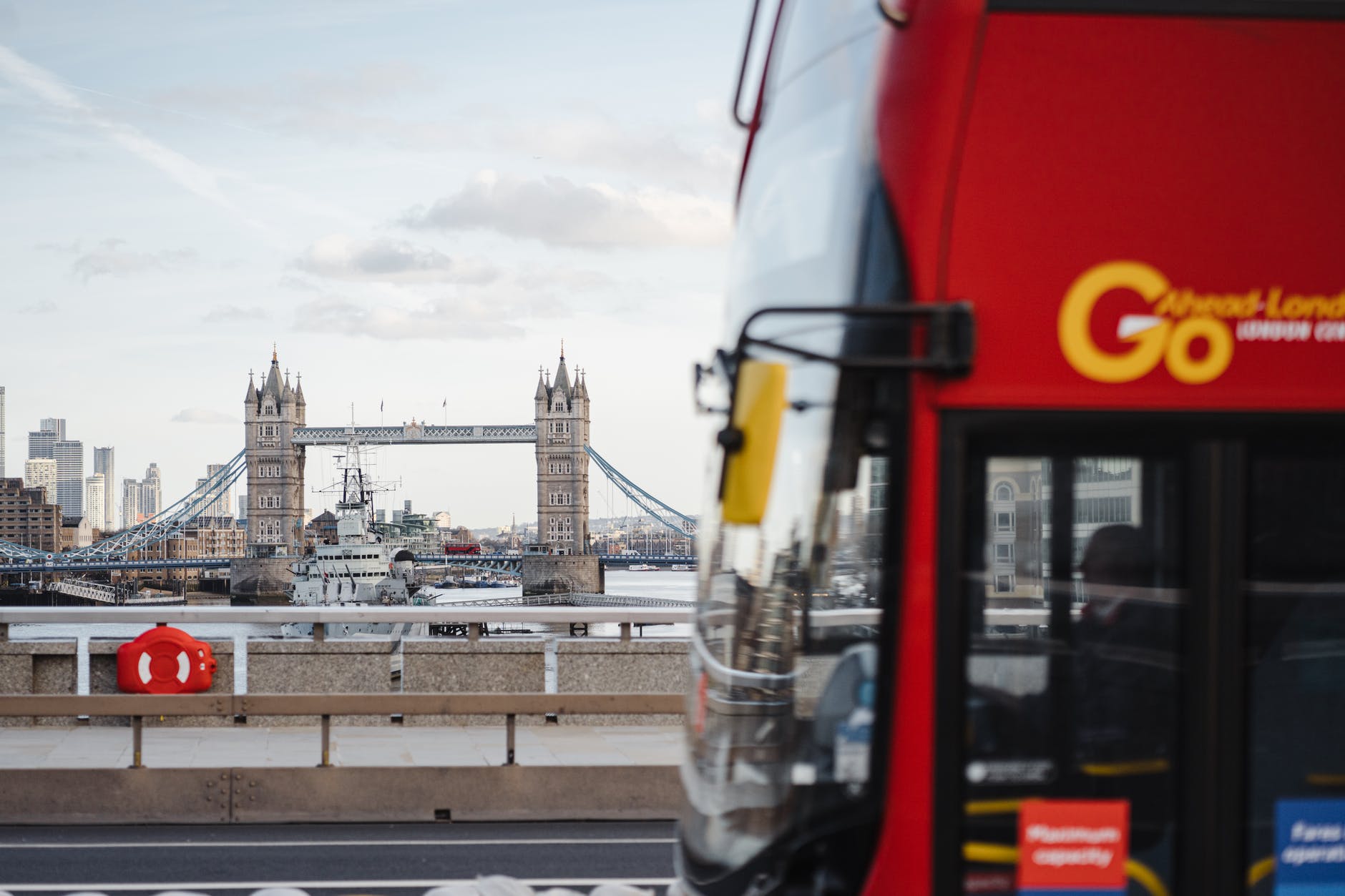 bus on the road with bridge on the river background