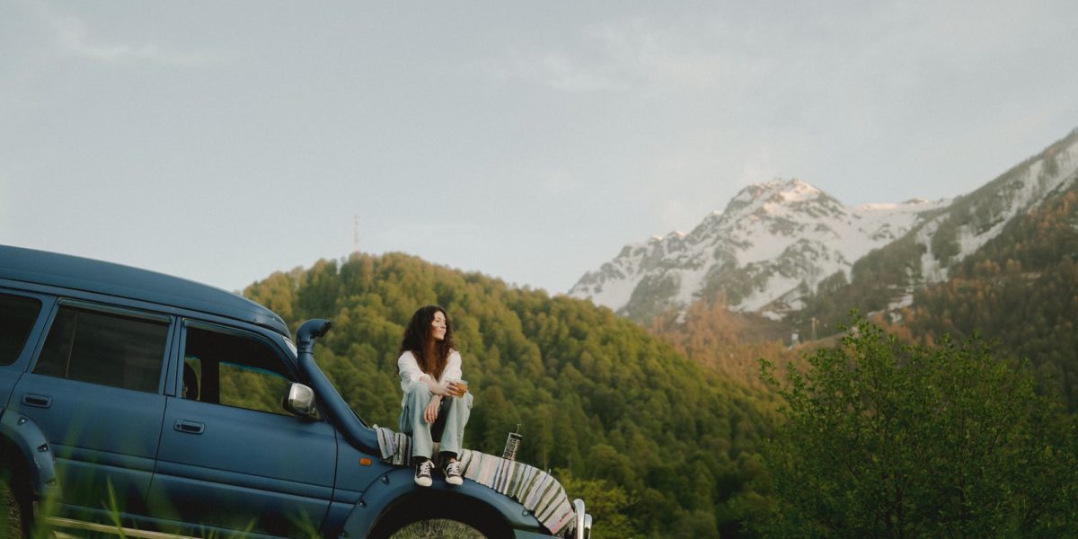 a woman sitting on a car