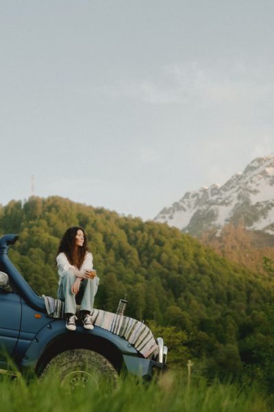 a woman sitting on a car