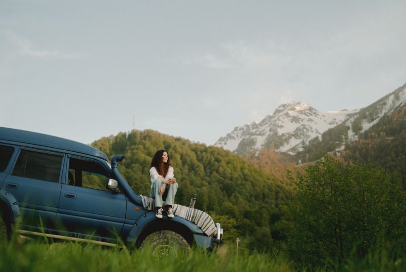 a woman sitting on a car