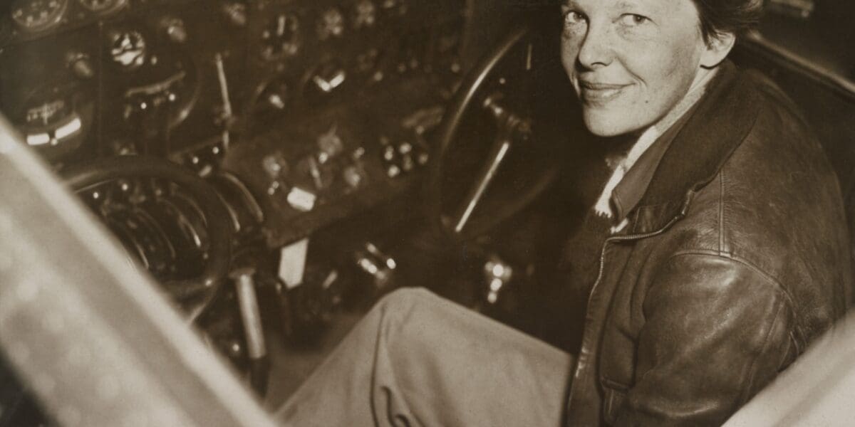 Amelia Earhart sitting in the cockpit | Everett Collection/Shutterstock