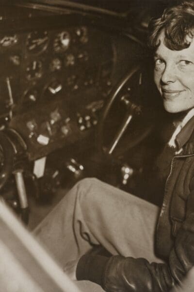 Amelia Earhart sitting in the cockpit | Everett Collection/Shutterstock