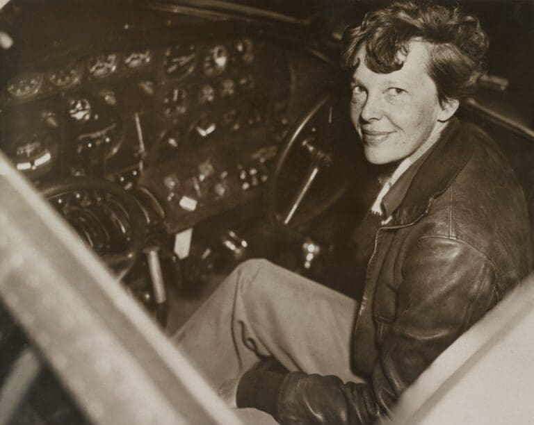Amelia Earhart sitting in the cockpit | Everett Collection/Shutterstock